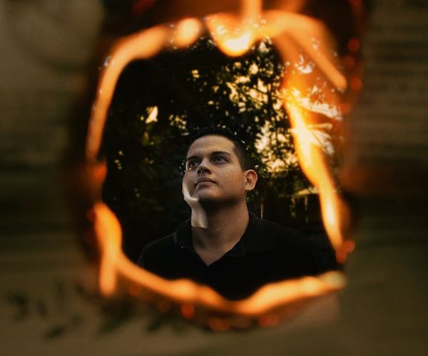 Silhouette of a man stretching against a sunrise, symbolizing energy.